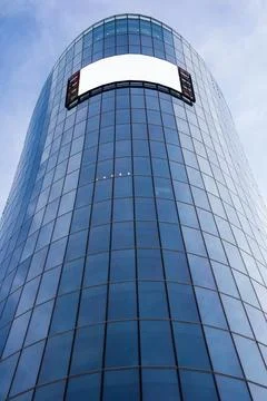 Bottom view of a modern skyscraper building with advertising board with empty Stock Photos