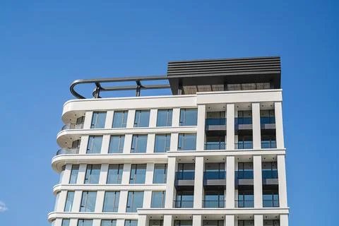 Bottom view of multi-storey building with round corner, panoramic balconies w 写真素材