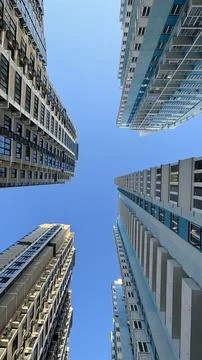 Bottom view of multi-storey buildings and sky Stock Photos