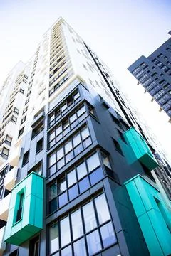 Bottom view of a multi-storey modern aqua colored building. urban jungle Stock Photos