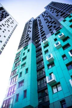 Bottom view of a multi-storey modern aqua colored building. urban jungle Stock Photos