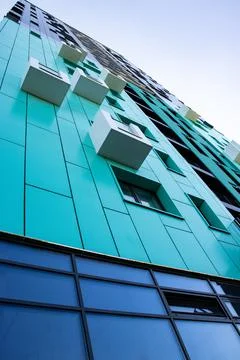 Bottom view of a multi-storey modern aqua colored building . urban jungle Stock Photos