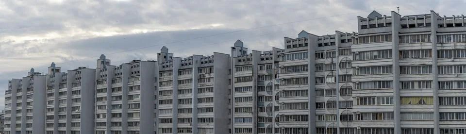 Bottom view of a multi-storey panel residential building on dramatic sky back Stock Photos