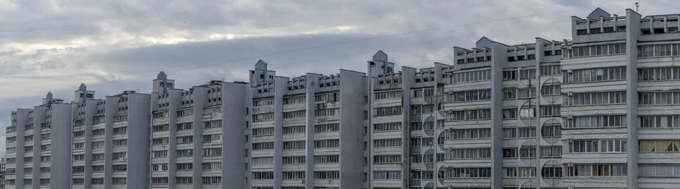 Bottom view of a multi-storey panel residential building on dramatic sky back Stock Photos