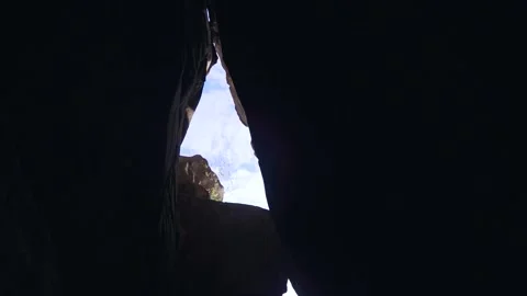 Bottom view from narrow gorge with sheer cliffs on bright sun and blue sky Stock Footage 233712850