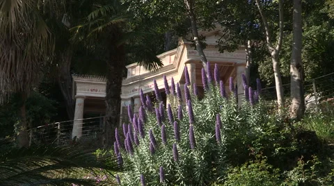 Bottom view of a neopompeian small  temple and purple flowers Stock Footage 56830644