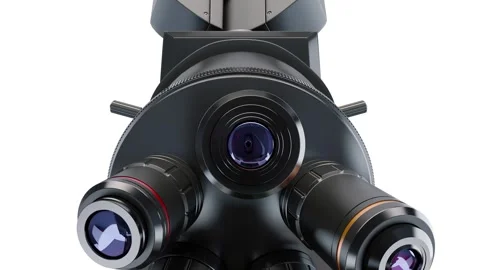Bottom view: objective lenses being turned above microscope stage. White back Stock Footage 295194494