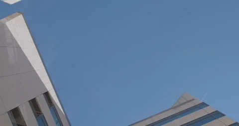 Bottom view of office building against the background of the blue sky Stock Footage 246628182