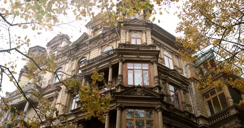 Bottom view of old city building during bright october day with golden trees Stock Footage 230487780