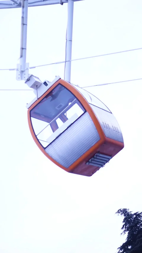 Bottom view on orange Ferris wheel cabin passes in front of camera Stock Footage 327864320