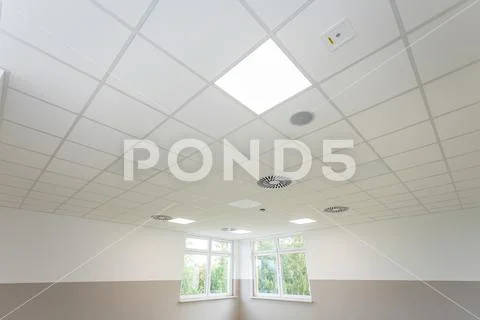 Bottom view of the panel ceiling on the diagonal of the room with a ...