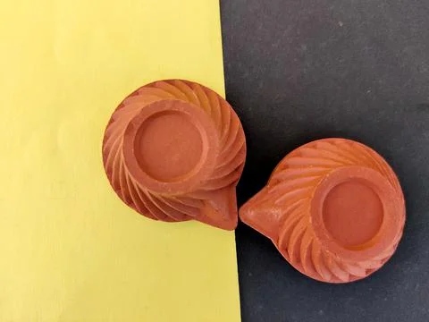 Bottom view of patterned clay lamps on yellow and black background Stock Photos