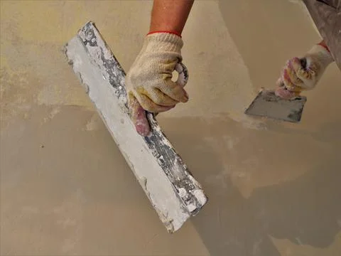 Bottom view of a plasterer's hands at work Stock Photos