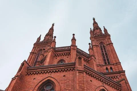 Bottom view of a red brick catholic church. Stock Photos