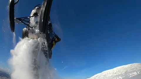 Bottom view. the rider on a snowmobile flying with a train of snow whirlwinds Video stock 99631687