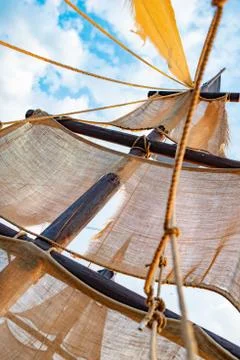 Bottom view of a ship mast with beige sails Stock-Fotos