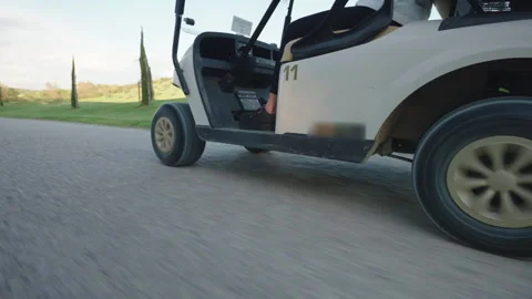 Bottom view shot of golf cart driving wheels along the road, typical transport Stock-Footage 273250698