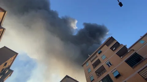 Bottom-up view shot of spreading toxic smoke above the buildings, smog emission Stock Footage 210221586