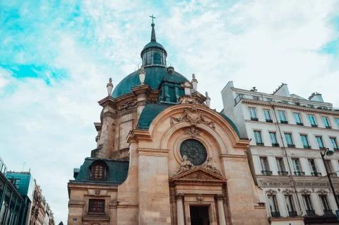 Bottom view shot of the Temple du Marais and a cloudy sky in Paris, France Stock Photos