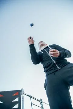 Bottom view of skilled man throwing and catching small balls Stock Photos