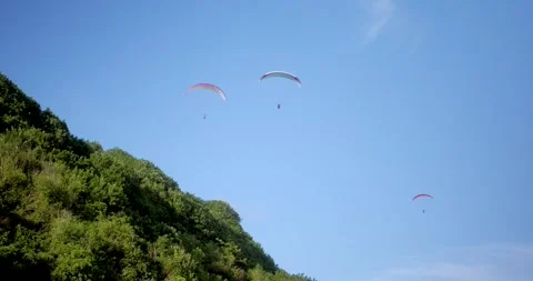 Bottom up view of the sky in which a group of people are flying on paragliders Stock Footage 273218297