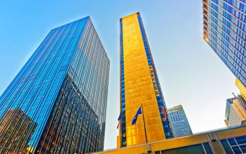 Bottom up view on Skyscraper with flags in Manhattan reflex Stock Photos