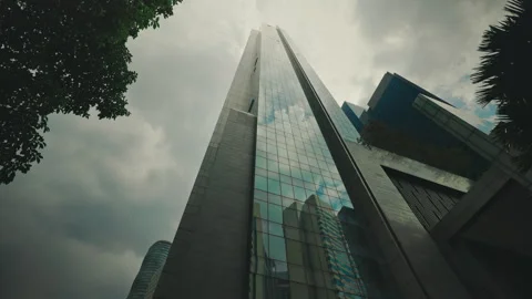 Bottom View of Skyscraper with Windows in Middle Reaches the Clouds. High-rise Stock Footage 276977166