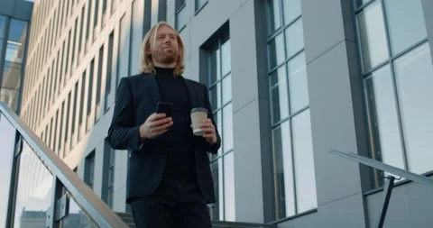 Bottom view of smiling ceo executive holding coffee paper cup and using Stock Footage 142782745