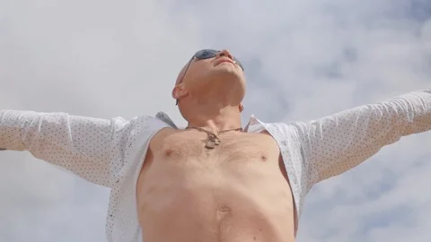 Bottom view of a standing man and spreading his arms against the background of Stock Footage 113278685