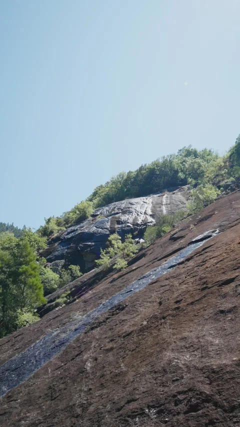 A bottom view of the steep, granite rock face Vídeos de archivo 295065648