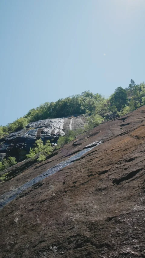 A bottom view of the steep, granite rock face 스톡 동영상 295065705
