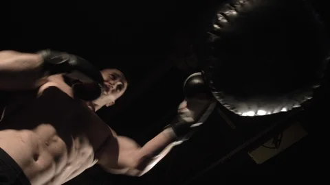 Bottom view strong daring young male boxer is boxing Stock Footage 112946076