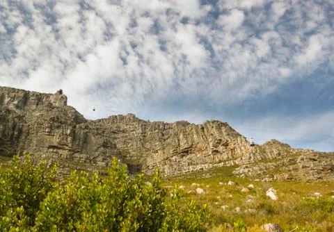 Bottom up view of Table Mountain with a cable car going Stock Photos