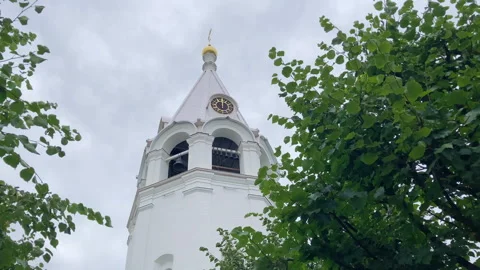 Bottom view of a tall white tower with a bell tower in the middle of nature Stock Footage 249721034