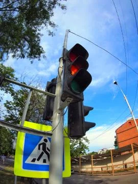 Bottom view on traffic light and road sign closeup Stock Photos