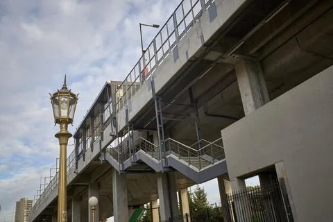 Bottom view of train tracks, platform and staircase. Cement and steel struc.. Stock Photos