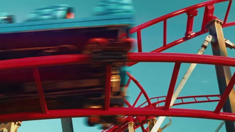 Bottom up view of twisting red roller coaster. Funfair and amusement park Stock Footage 245745697