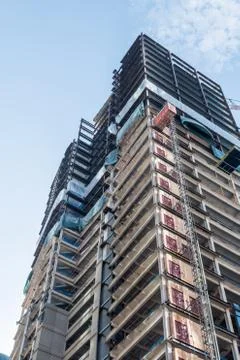 Bottom view of an under construction skyscraper in Seattle on a clear day. Stock Photos