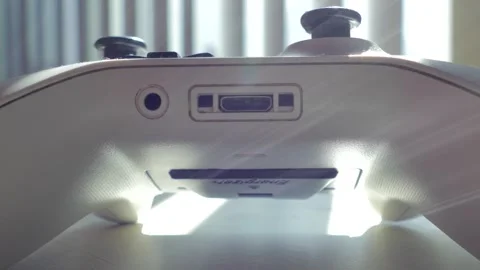 Bottom view of white gaming controller showing expansion and audio ports Stock-Footage 331044716