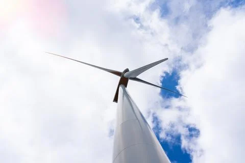 Bottom view of wind turbine generating electricity clean energy with cloud and Stock Photos
