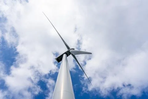 Bottom view of wind turbine generating electricity clean energy with cloud and Stock Photos