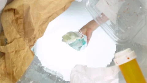 Bottom-up view of a woman throwing face mask into the trash can. Slow-motion Stock Footage 163479664