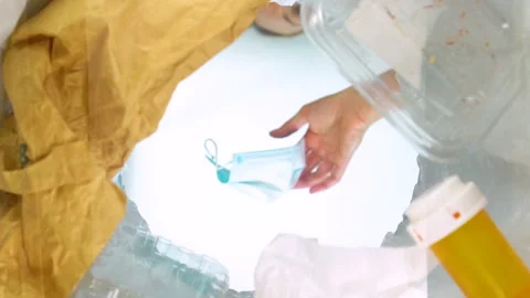 Bottom-up view of a woman throwing face mask into the trash can. Slow-motion Vídeos de archivo 163479969