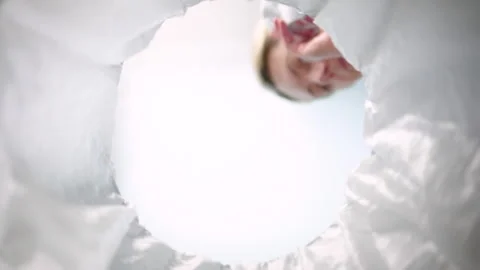 Bottom-up view of a woman throwing face mask into the trash can. Slow-motion Stock Footage 163480116