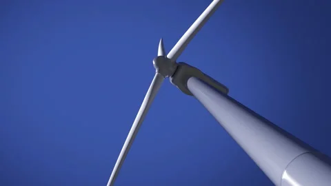 Bottom view of working wind turbine power generator against clear blue sky, loop Video stock 153233522