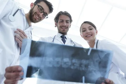Bottom view young group of doctors looking at x-ray Stock Photos