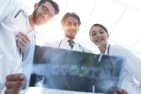 Bottom view young group of doctors looking at x-ray Stock Photos