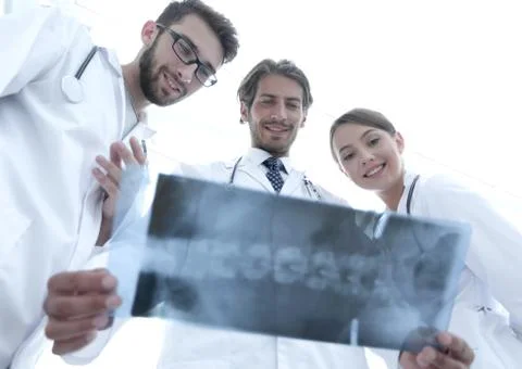 Bottom view young group of doctors looking at x-ray Stock Photos
