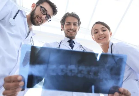 Bottom view young group of doctors looking at x-ray Stock Photos