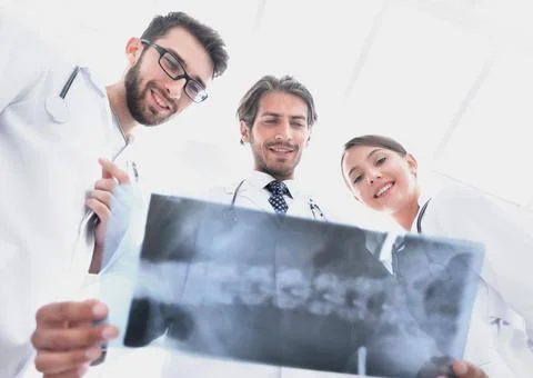 Bottom view young group of doctors looking at x-ray Stock Photos